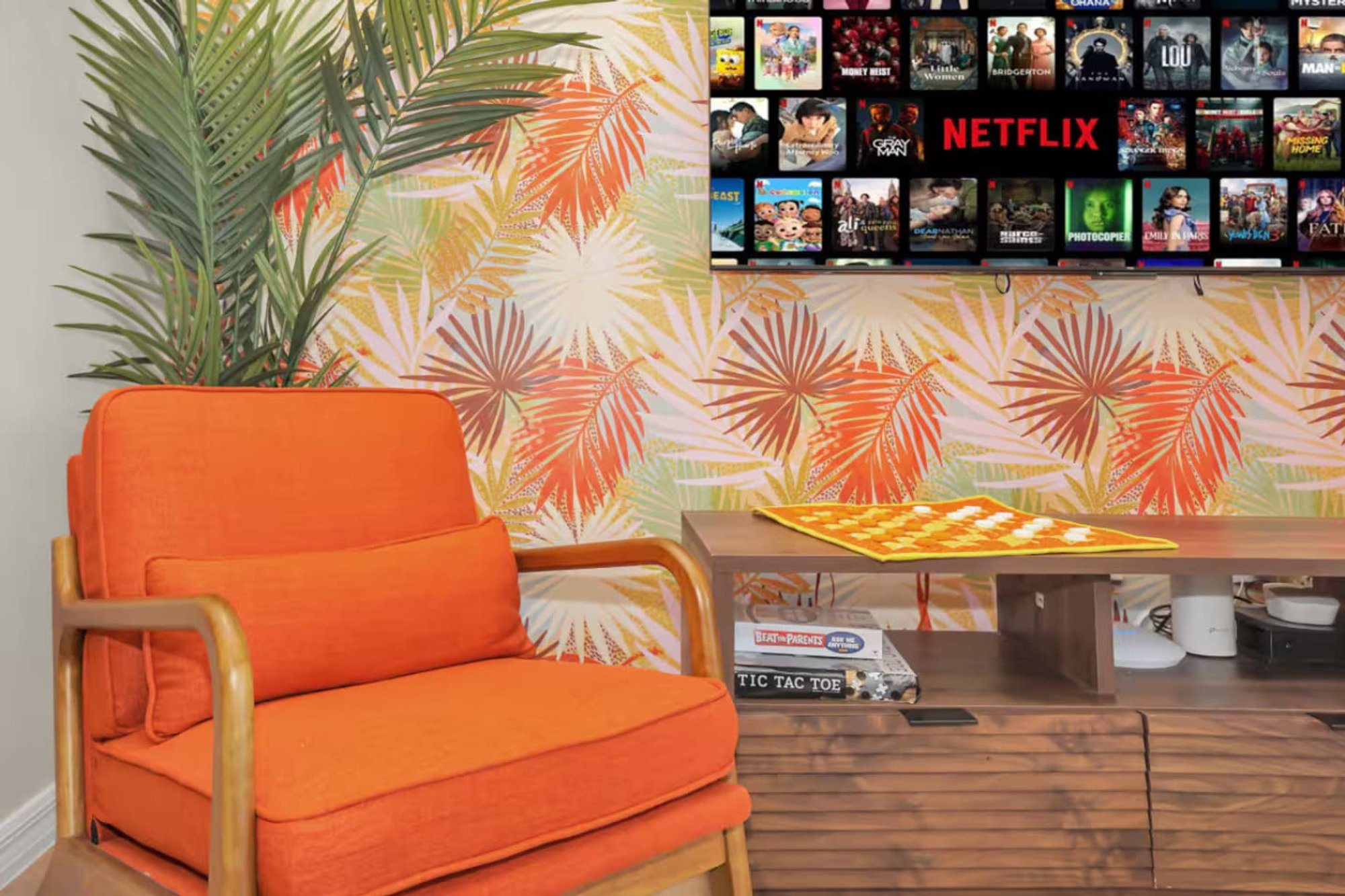 Orange armchair beside the media console