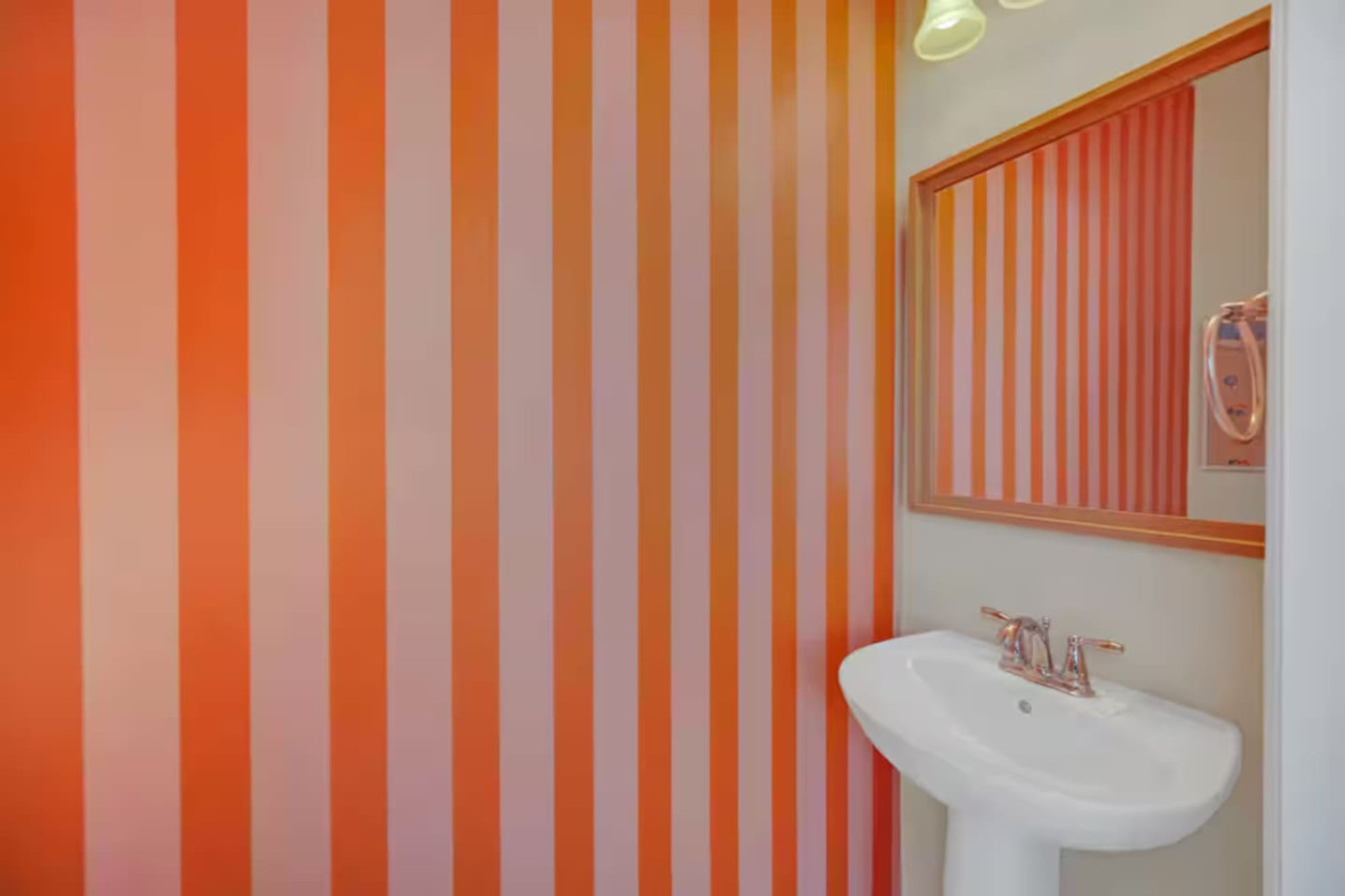 Powder room with the orange striped wall