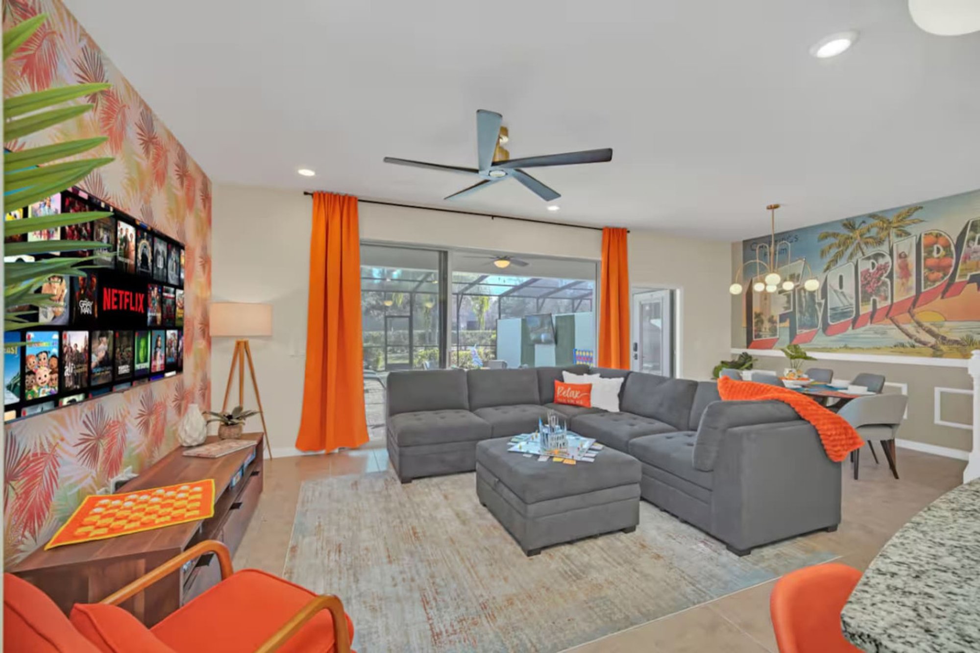 Grey sectional facing the living room TV wall