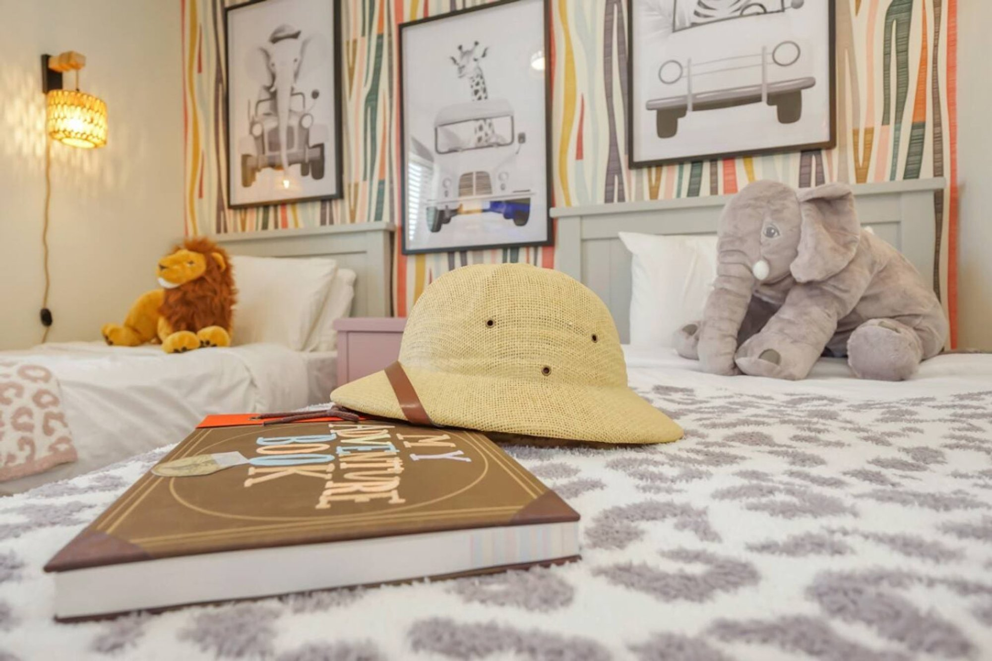 Stuffed lion and safari hat on a twin bed in Bedroom 4