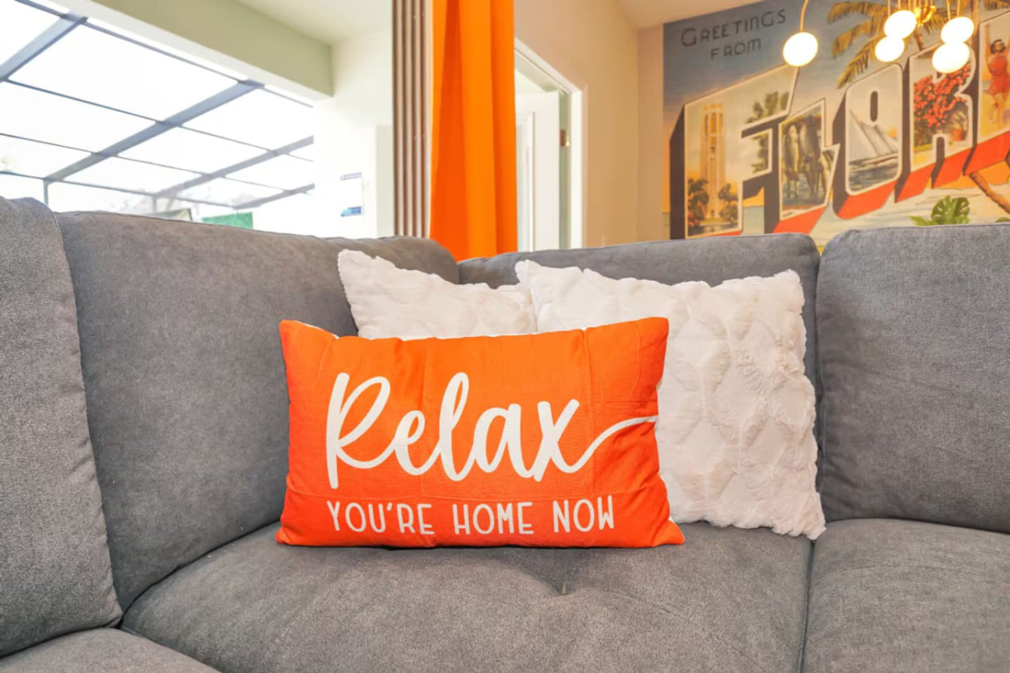 Relax, You're Home Now cushion on the living room sectional