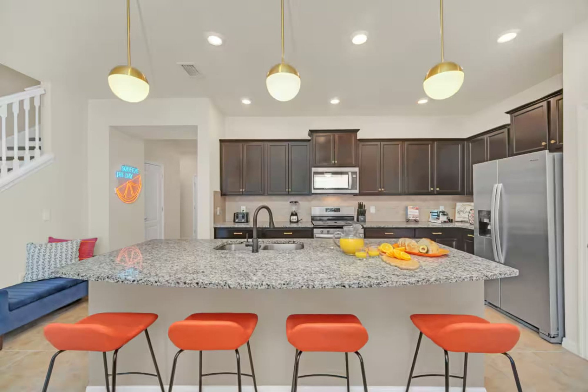 Kitchen island with orange counter stools