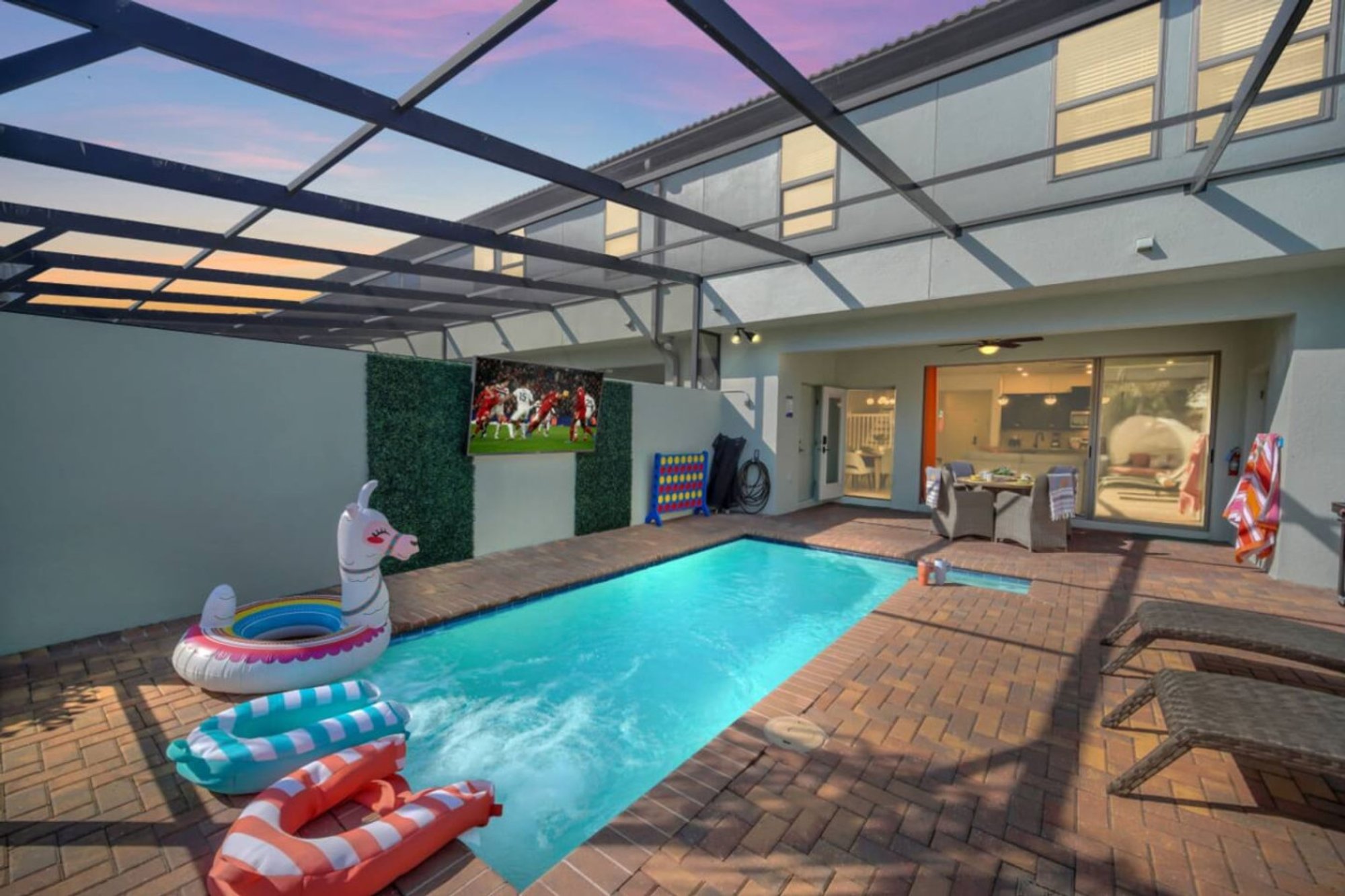 Pool floats in the private pool with the outdoor TV behind