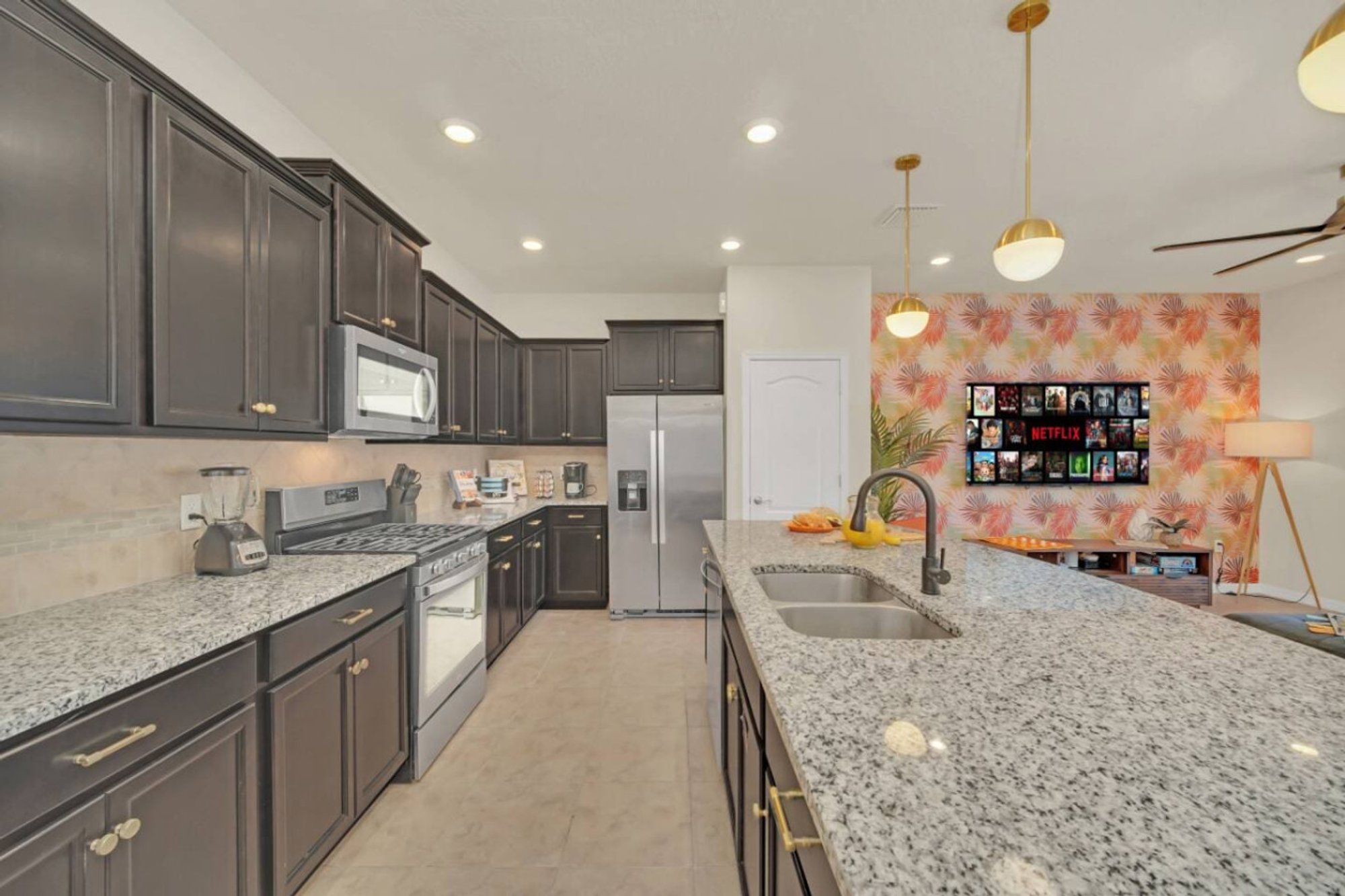 Kitchen with granite counters and the blossom wallpaper beyond