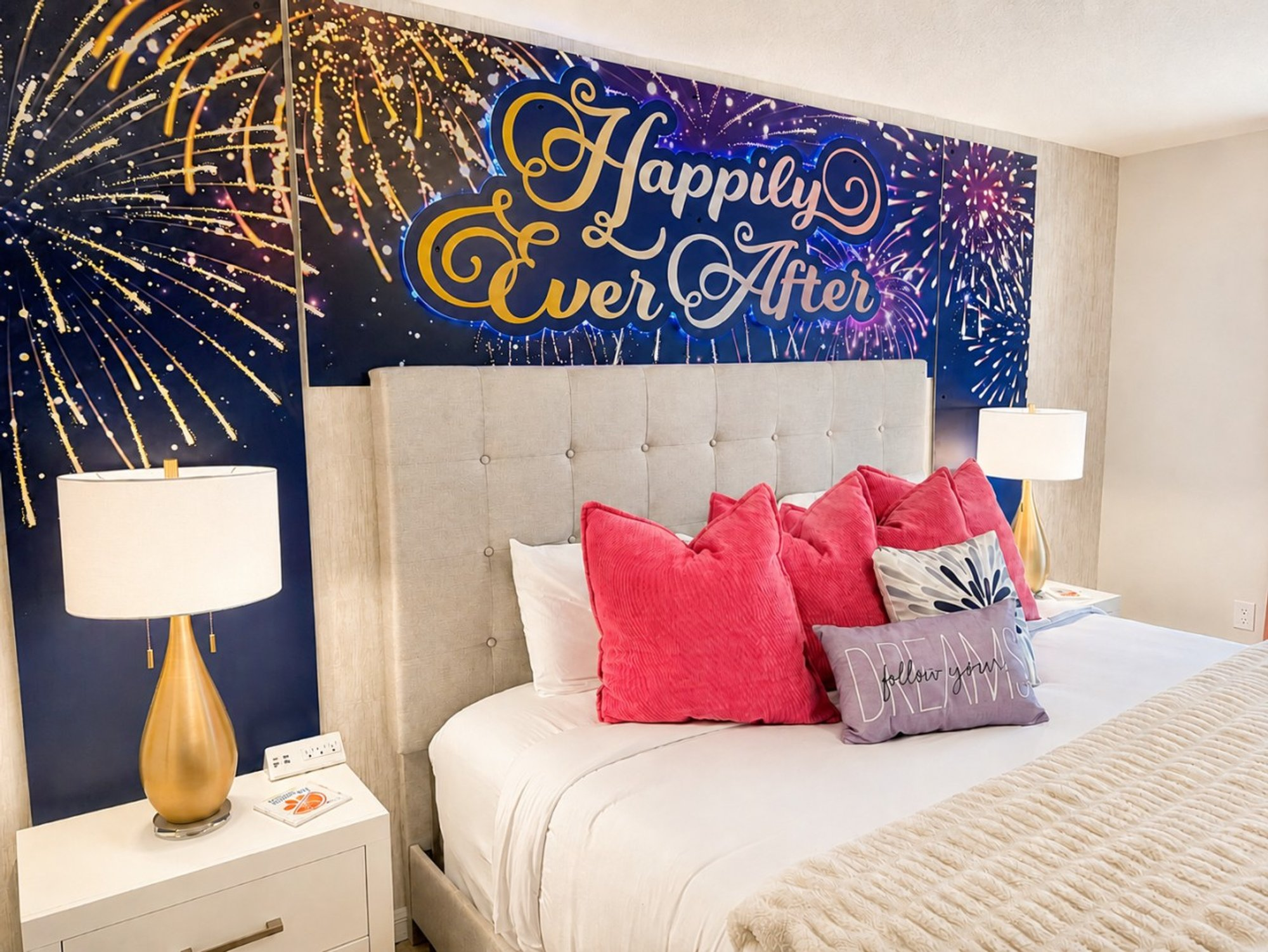 Happily Ever After mural behind the king bed in the primary suite