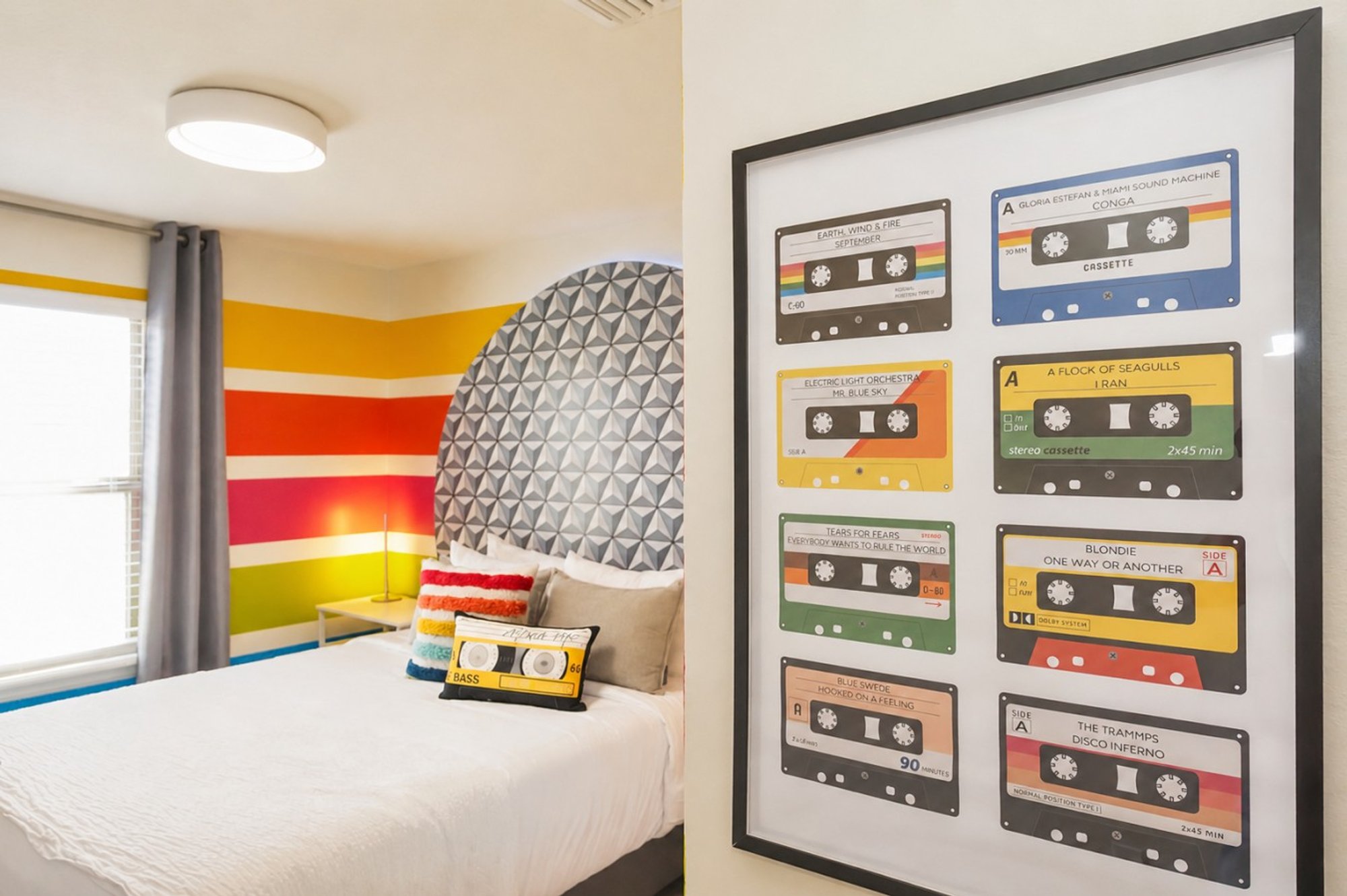 Cassette-tape wall art above the striped wall in Bedroom 5