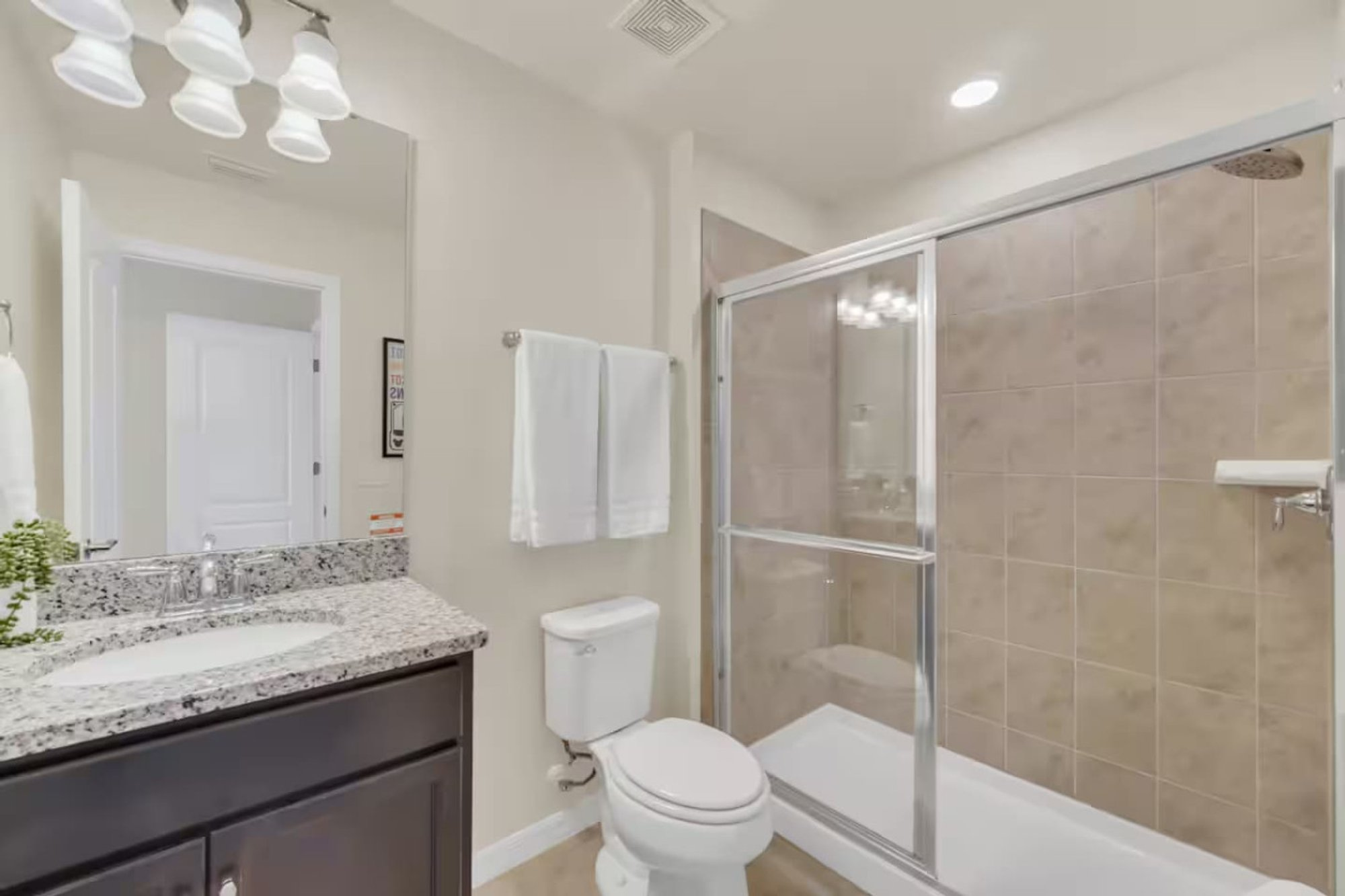 Bath with a walk-in shower and granite vanity